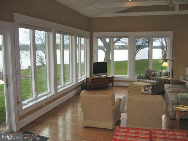 1612 Deep Point Road Woolford, MD 21677 - Photo 11 of 30 a living room with furniture and floor to ceiling windows
