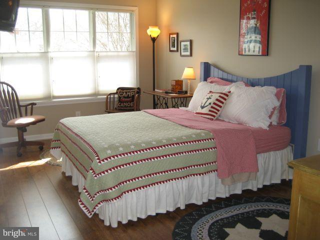 1612 Deep Point Road Woolford, MD 21677 - Photo 16 of 30 a bed room with a bed and a chair