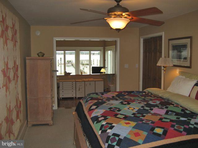 1612 Deep Point Road Woolford, MD 21677 - Photo 3 of 30 a bedroom with a bed and a chandelier
