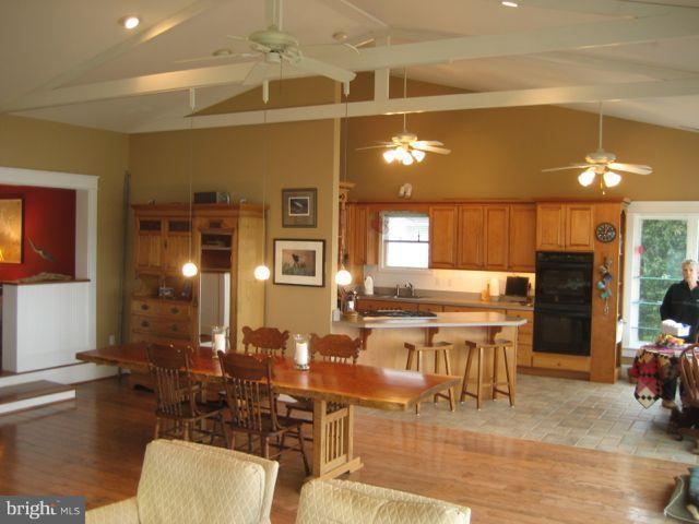 1612 Deep Point Road Woolford, MD 21677 - Photo 9 of 30 a kitchen with a table chairs and a view of living room