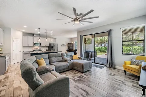 a bedroom with a bed dresser and a chandelier