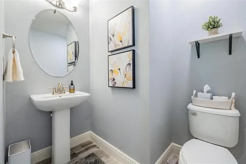 a spacious bedroom with a bed and a flat screen tv