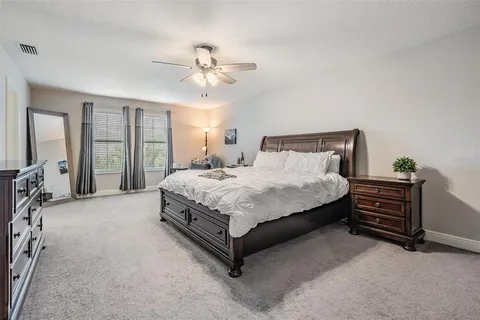 a bathroom with a granite countertop sink a mirror and a bathtub