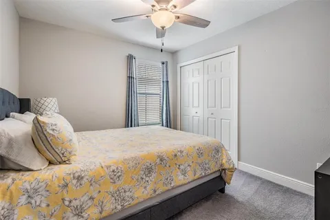 a bathroom with a granite countertop sink mirror vanity and toilet