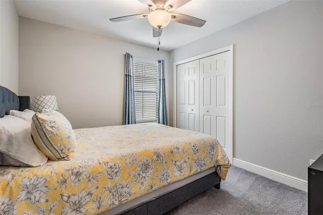a bathroom with a granite countertop sink mirror vanity and toilet