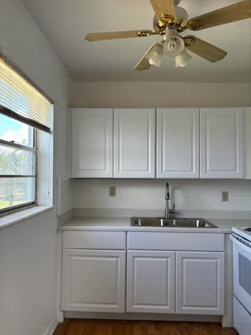 a kitchen with a sink cabinets and window