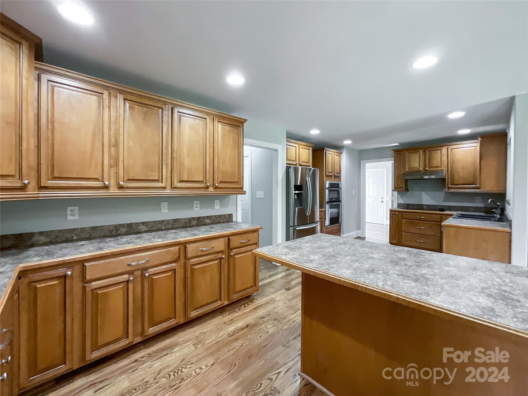 2510 Doster Road Monroe, NC 28112 - Photo 15 of 48 a kitchen with stainless steel appliances granite countertop a stove a sink and a refrigerator