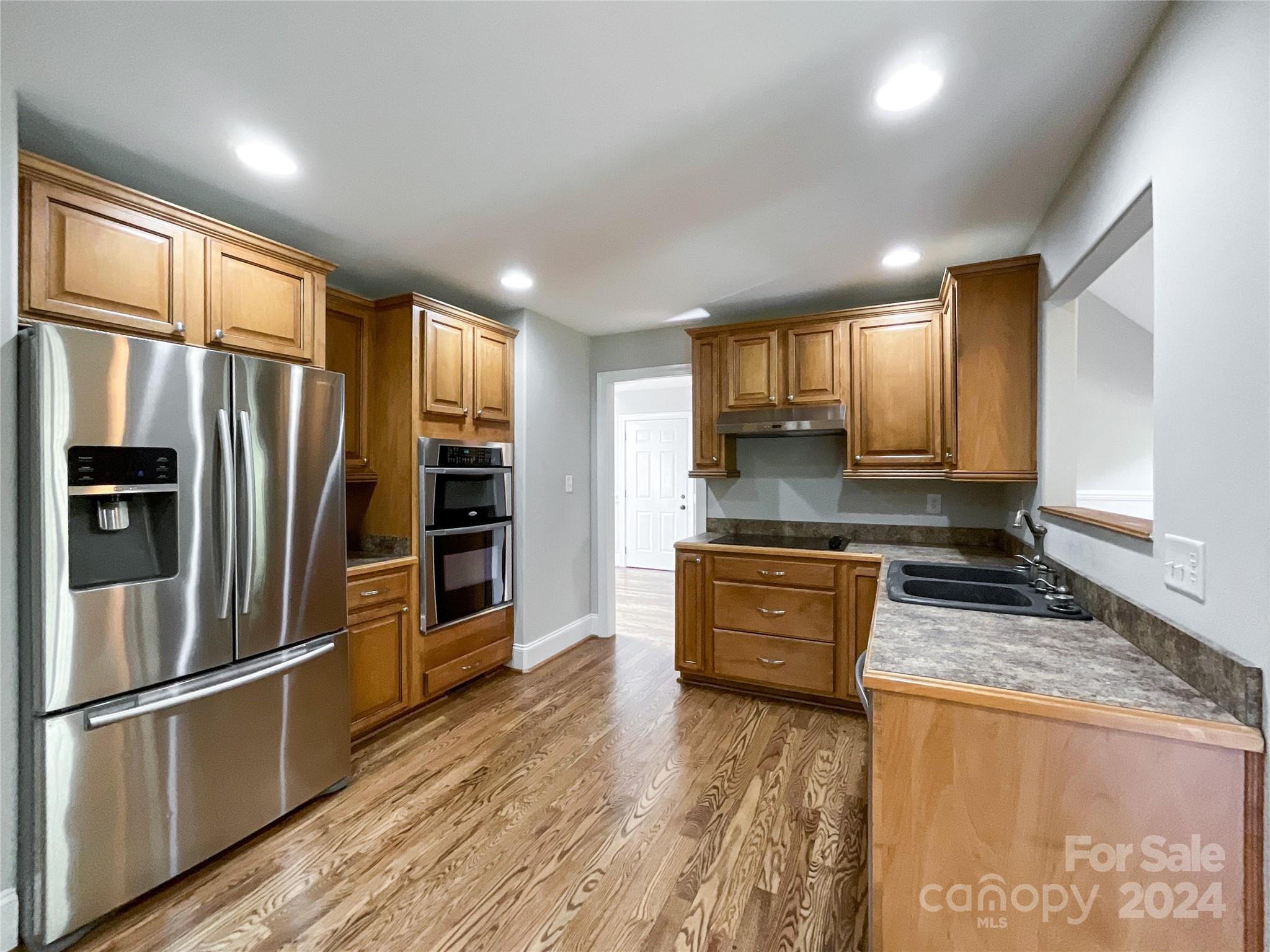 2510 Doster Road Monroe, NC 28112 - Photo 17 of 48 a kitchen with granite countertop a refrigerator stove and oven