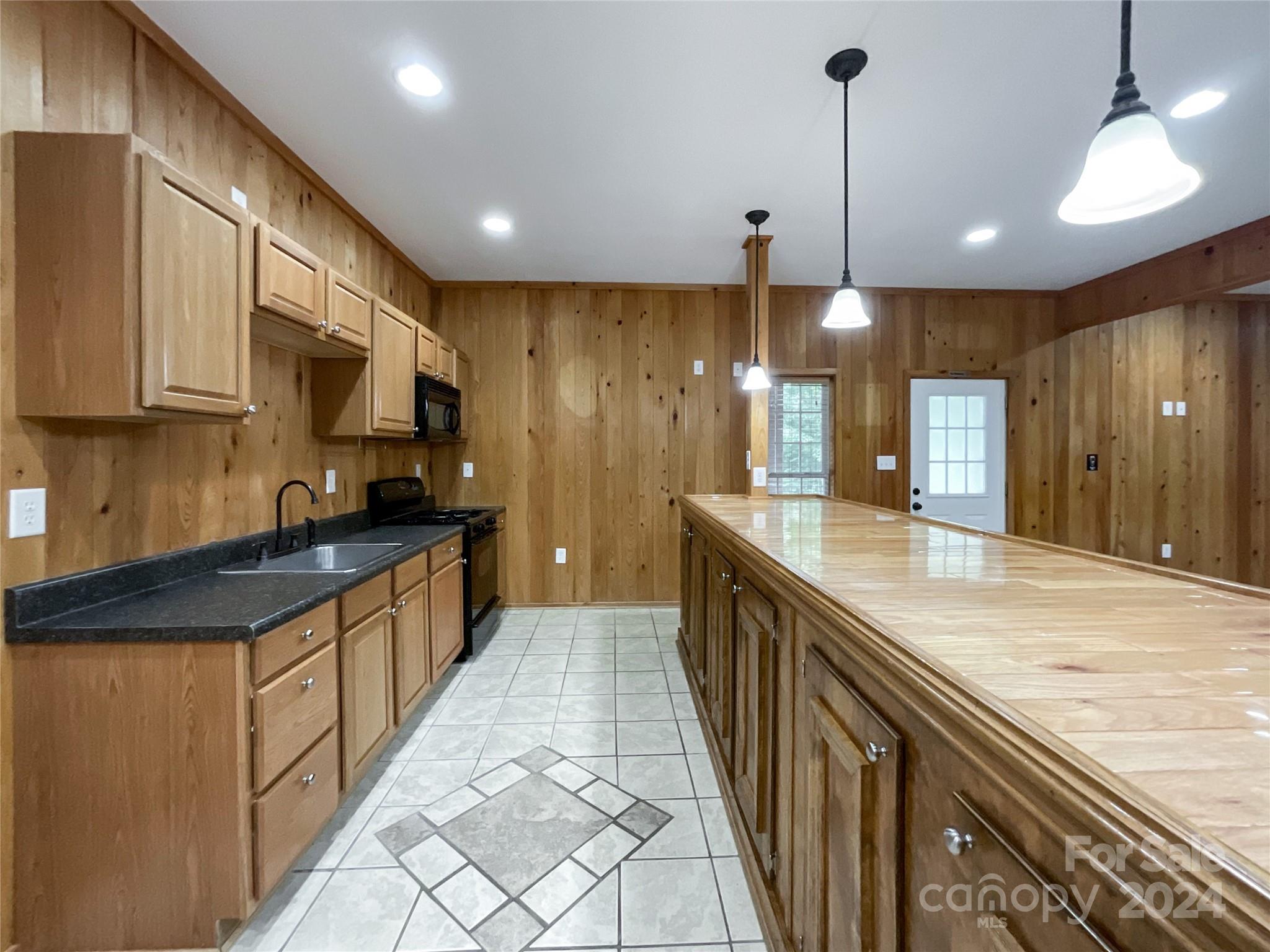 2510 Doster Road Monroe, NC 28112 - Photo 40 of 48 a large kitchen with granite countertop a large counter top space appliances and cabinets
