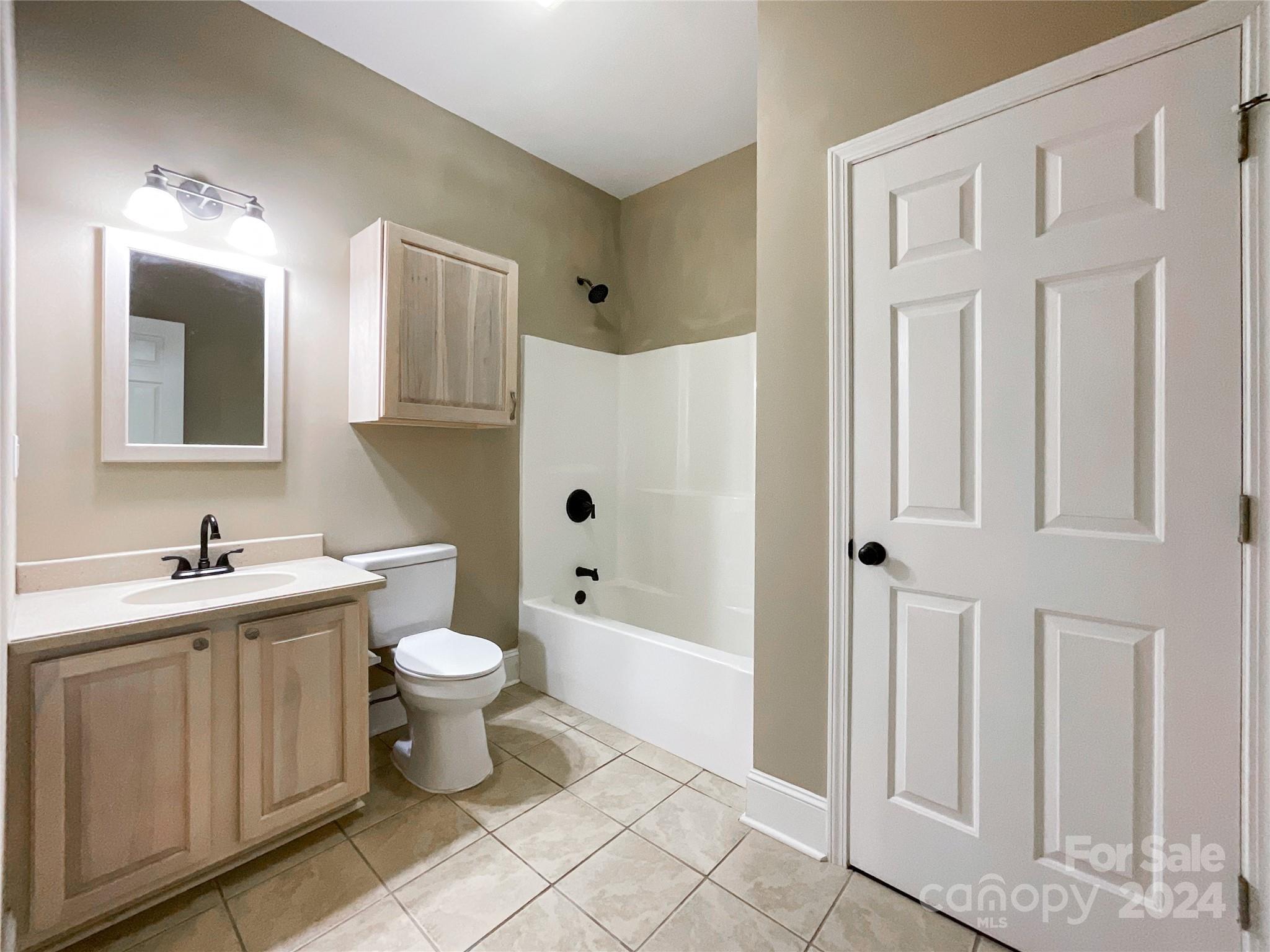 2510 Doster Road Monroe, NC 28112 - Photo 43 of 48 a bathroom with a toilet sink and mirror