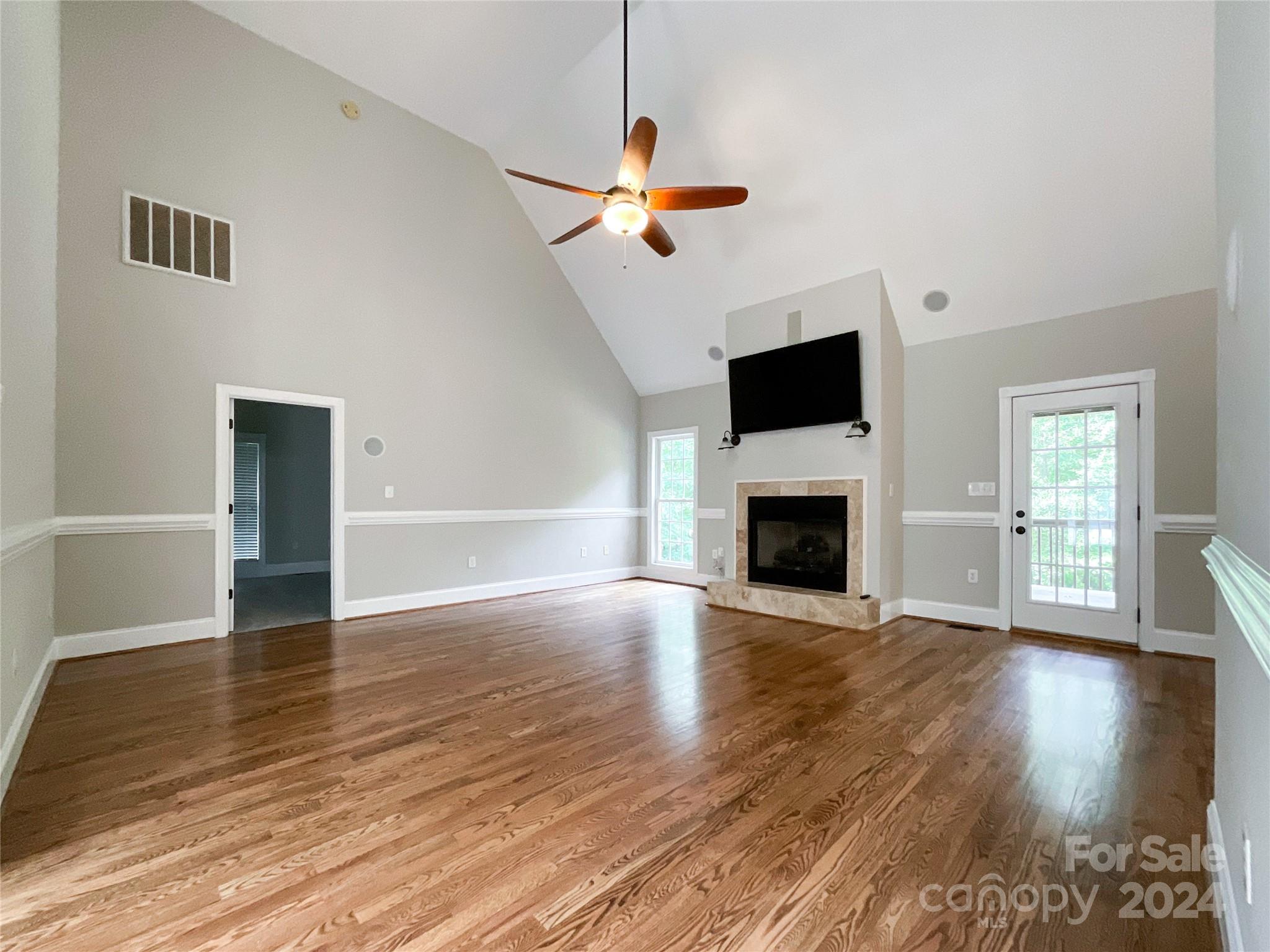 2510 Doster Road Monroe, NC 28112 - Photo 8 of 48 a view of a livingroom with wooden floor a fireplace and windows