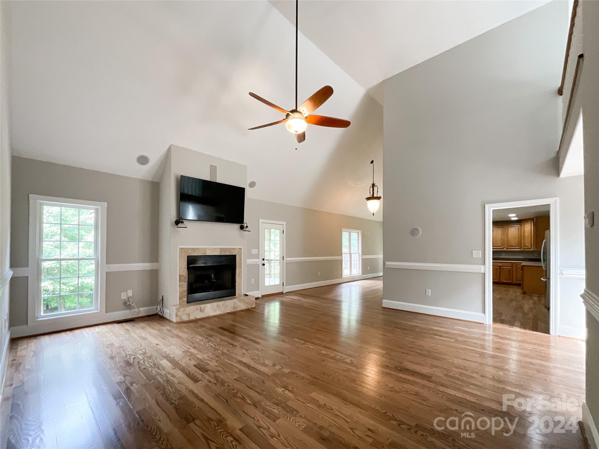 2510 Doster Road Monroe, NC 28112 - Photo 9 of 48 a view of a livingroom with a fireplace a ceiling fan and wooden floor
