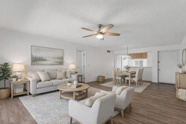 an empty room with wooden floor and ceiling fan