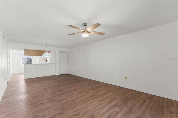 a kitchen with a sink a stove a refrigerator cabinets and a window