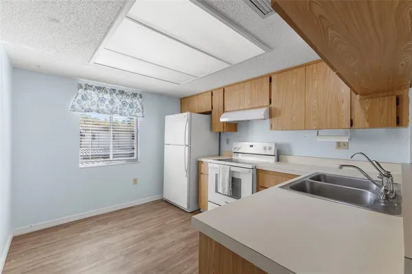 a kitchen with a white cabinets and white appliances