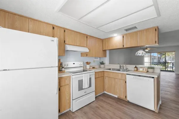a kitchen with a white cabinets and white appliances