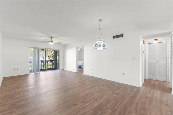 a living room with furniture chandelier and a view of living room