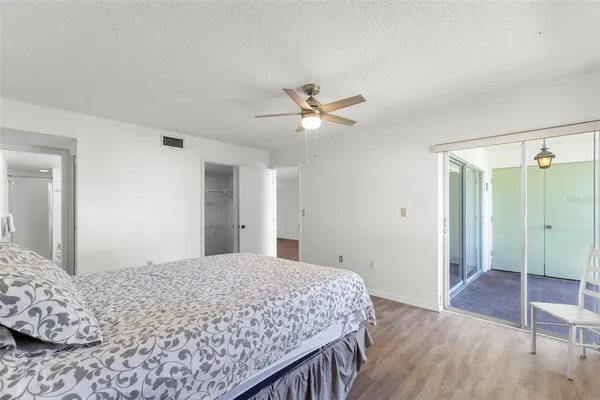 a bedroom with a large bed and a chandelier