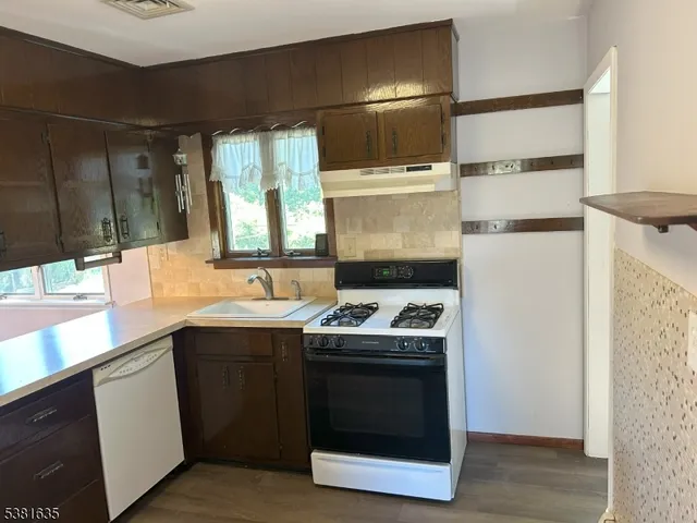 a kitchen with a sink stove and cabinets
