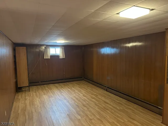 an empty room with wooden floor and windows in a room