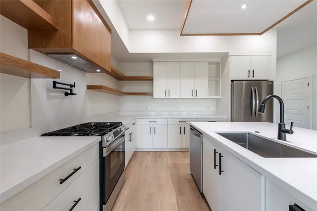 a kitchen with a sink a stove and refrigerator