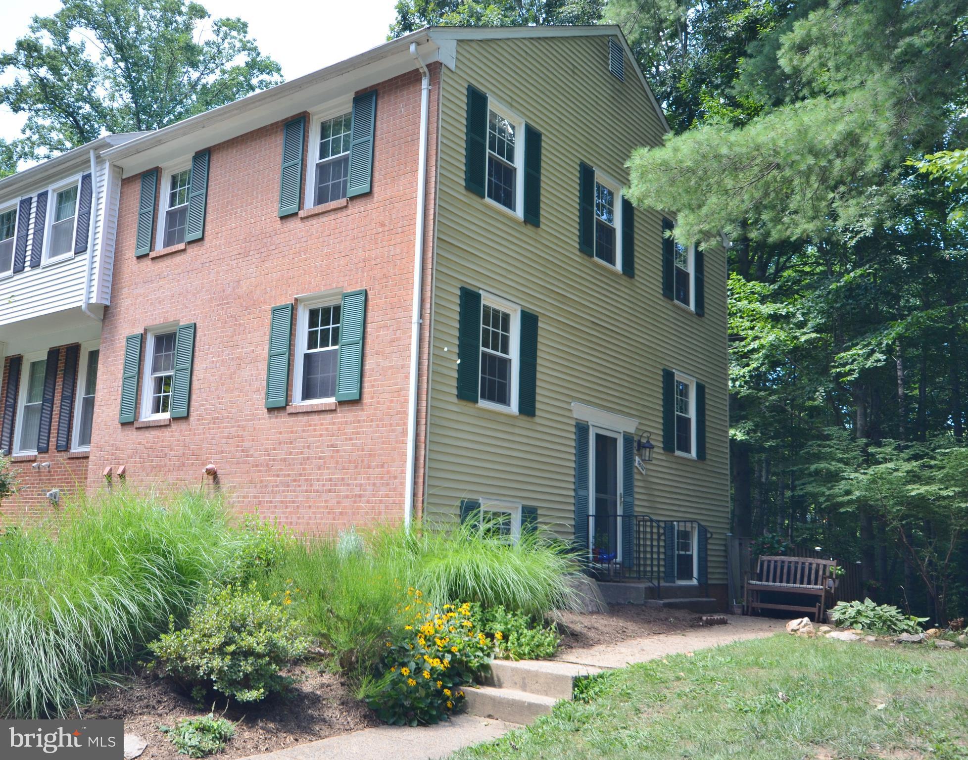 End house is surrounded by woods.