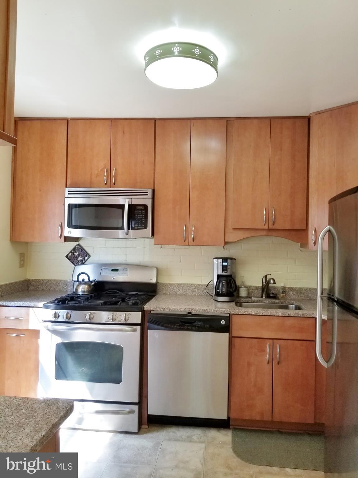 Tall cabinets, fitted drawers, granite, Gas stove.