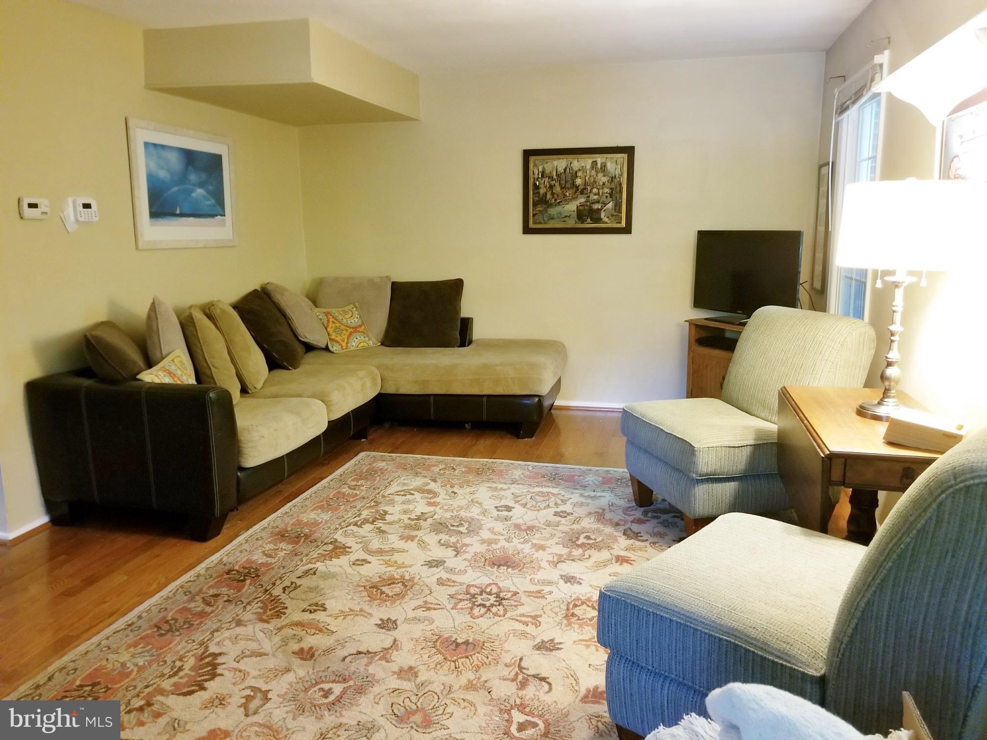Large living room features hardwoods.
