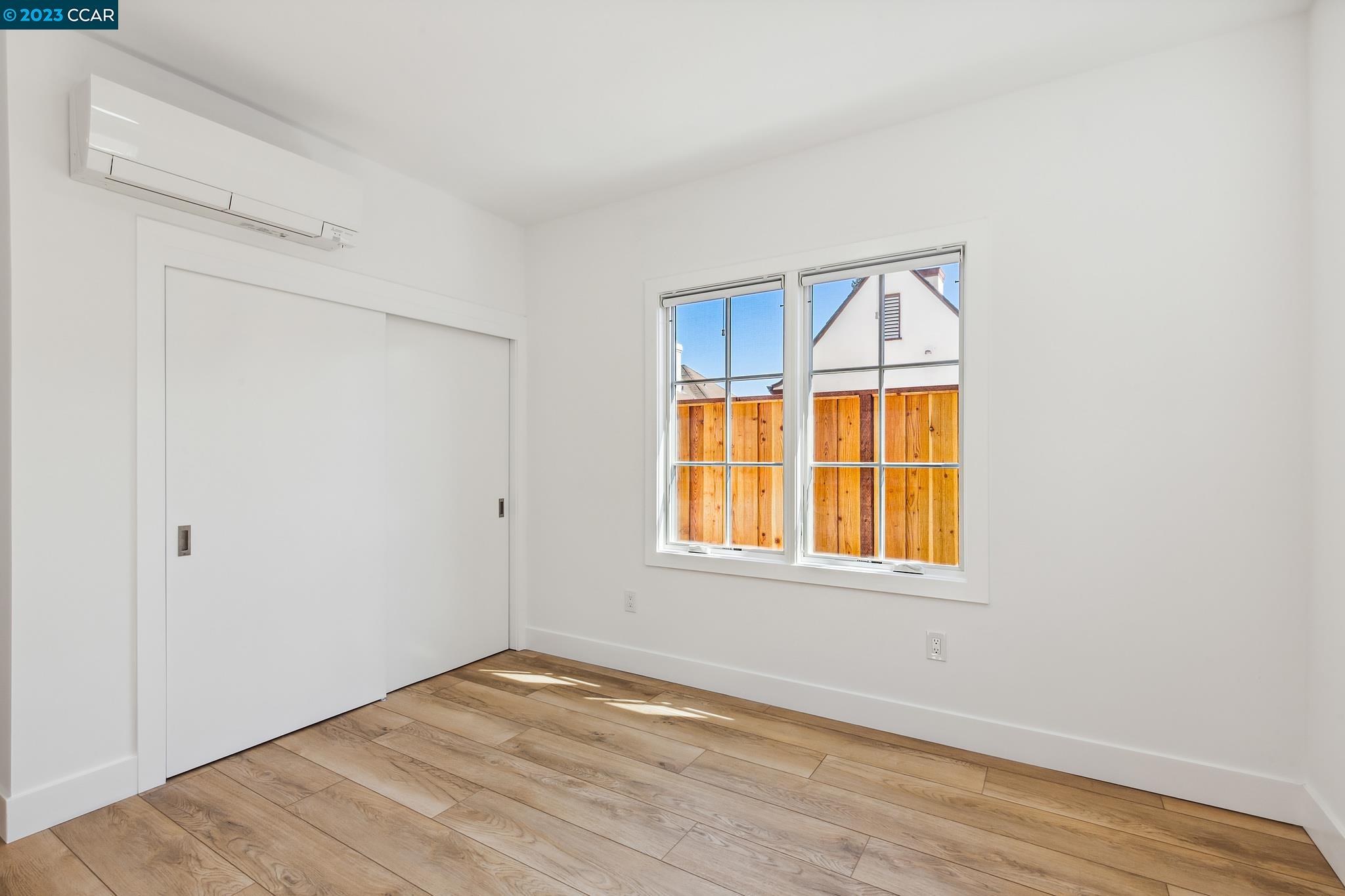 833 Paramount Road Oakland, CA 94610 - Photo 11 of 15 a view of an empty room with wooden floor and a window