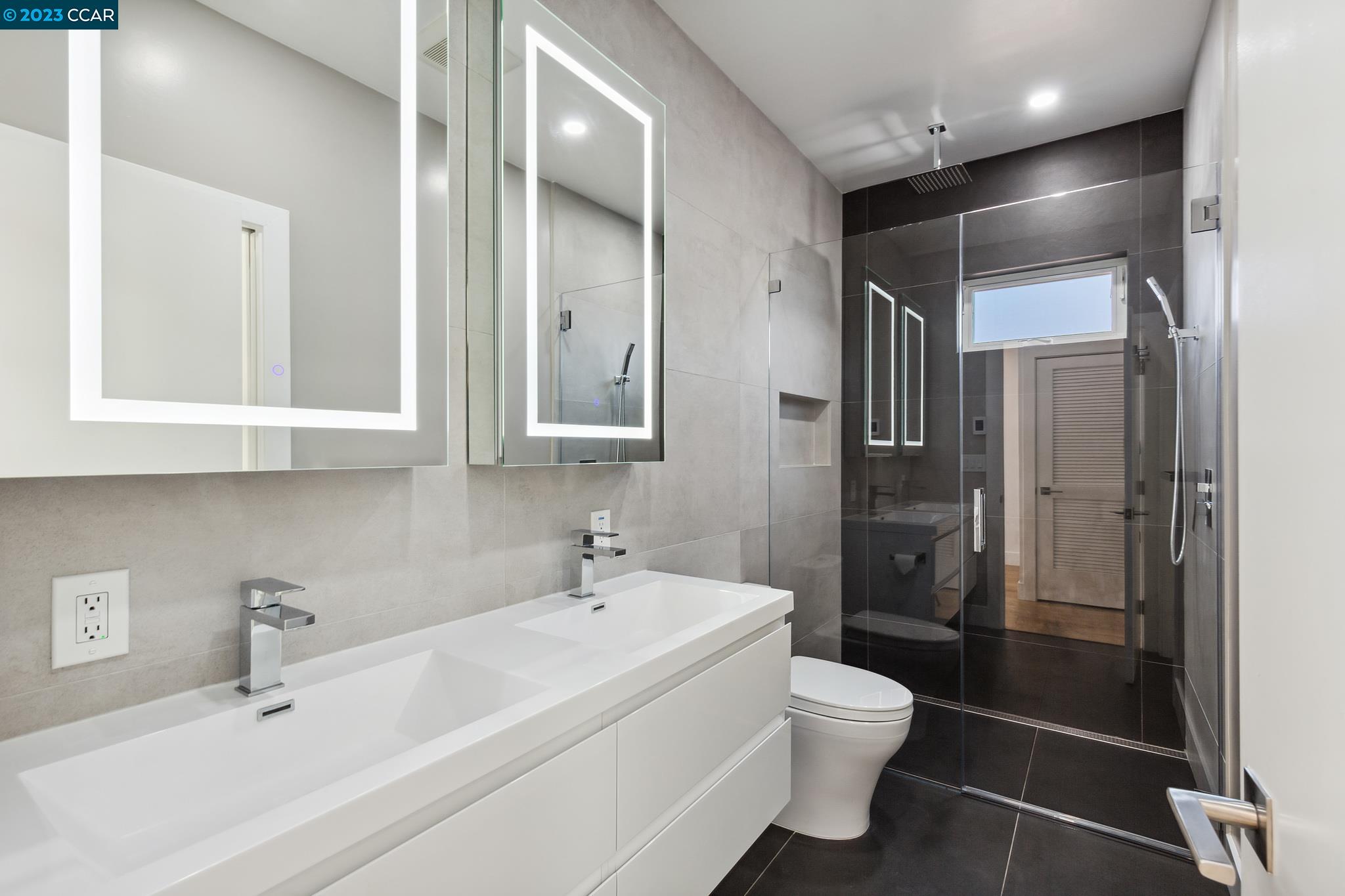 833 Paramount Road Oakland, CA 94610 - Photo 12 of 15 a bathroom with a double vanity sink toilet and shower