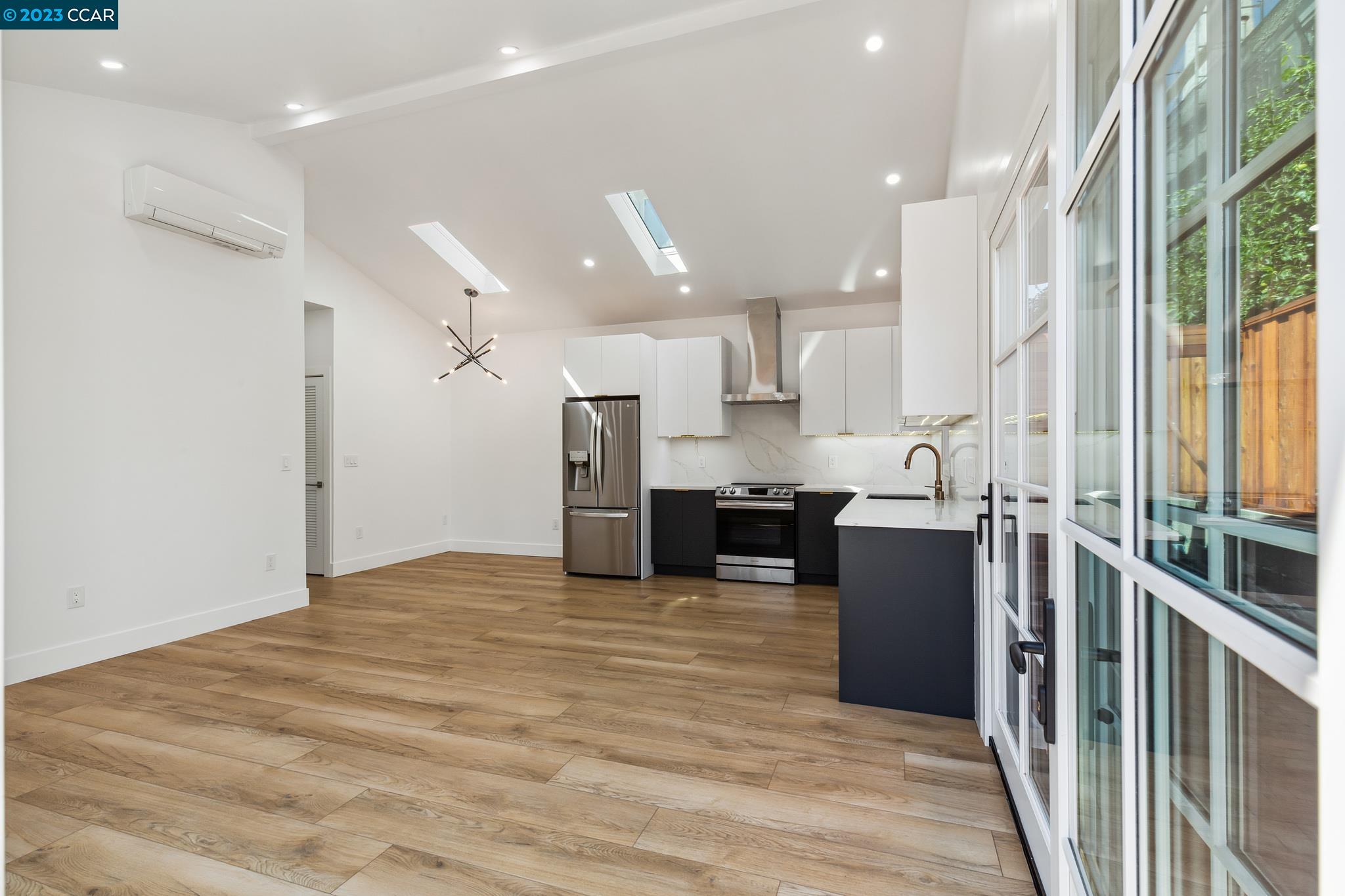 833 Paramount Road Oakland, CA 94610 - Photo 3 of 15 a view of a kitchen with kitchen island a counter top space a sink stainless steel appliances and cabinets