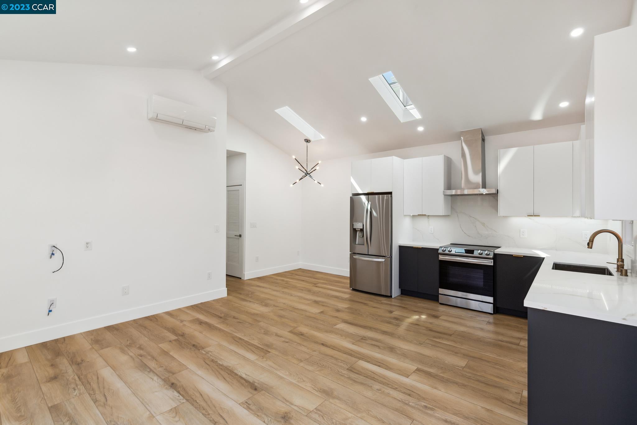 833 Paramount Road Oakland, CA 94610 - Photo 4 of 15 a kitchen with stainless steel appliances kitchen island granite countertop a refrigerator and a sink