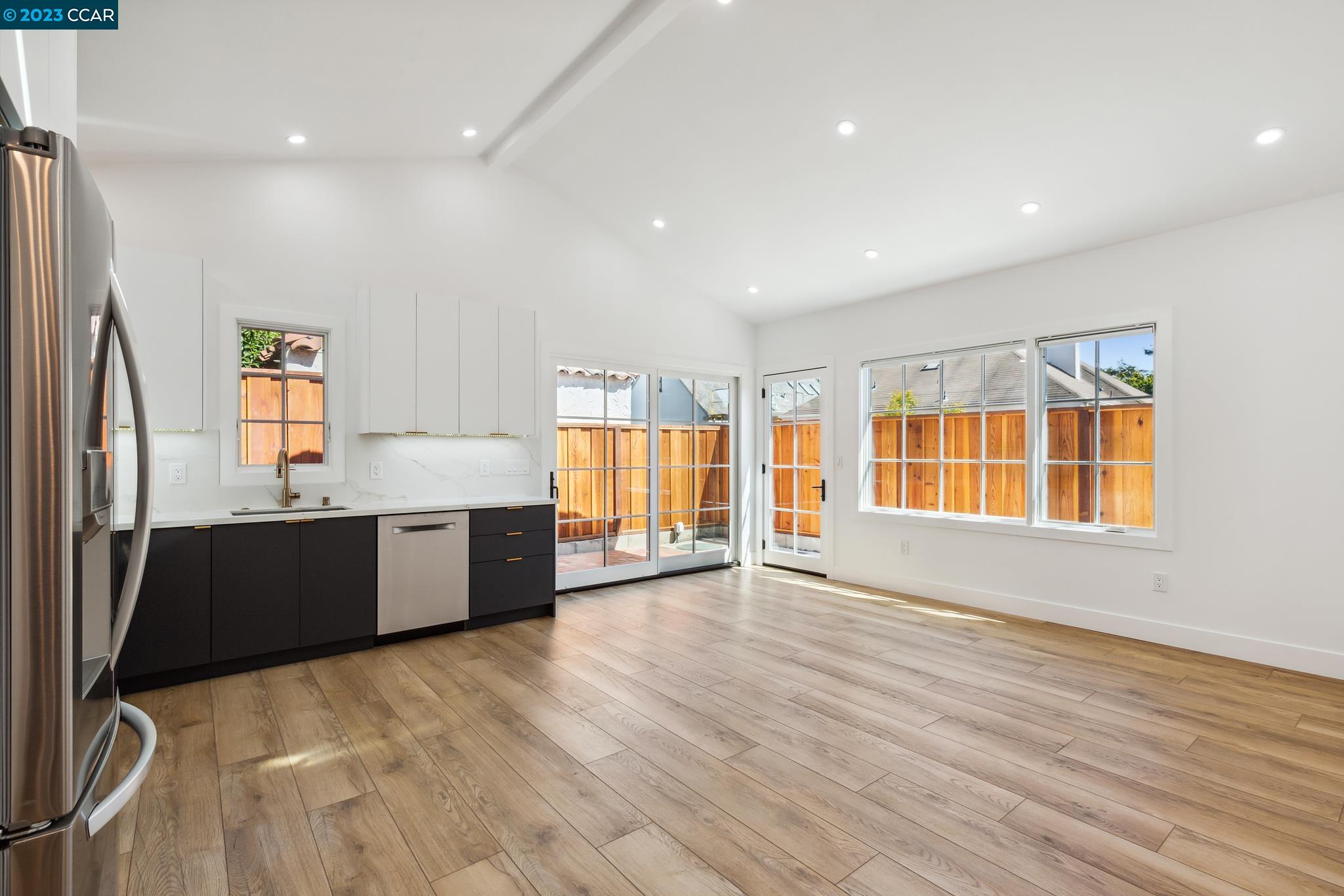 833 Paramount Road Oakland, CA 94610 - Photo 6 of 15 a large kitchen with stainless steel appliances granite countertop a large counter top a wooden floor and a large window