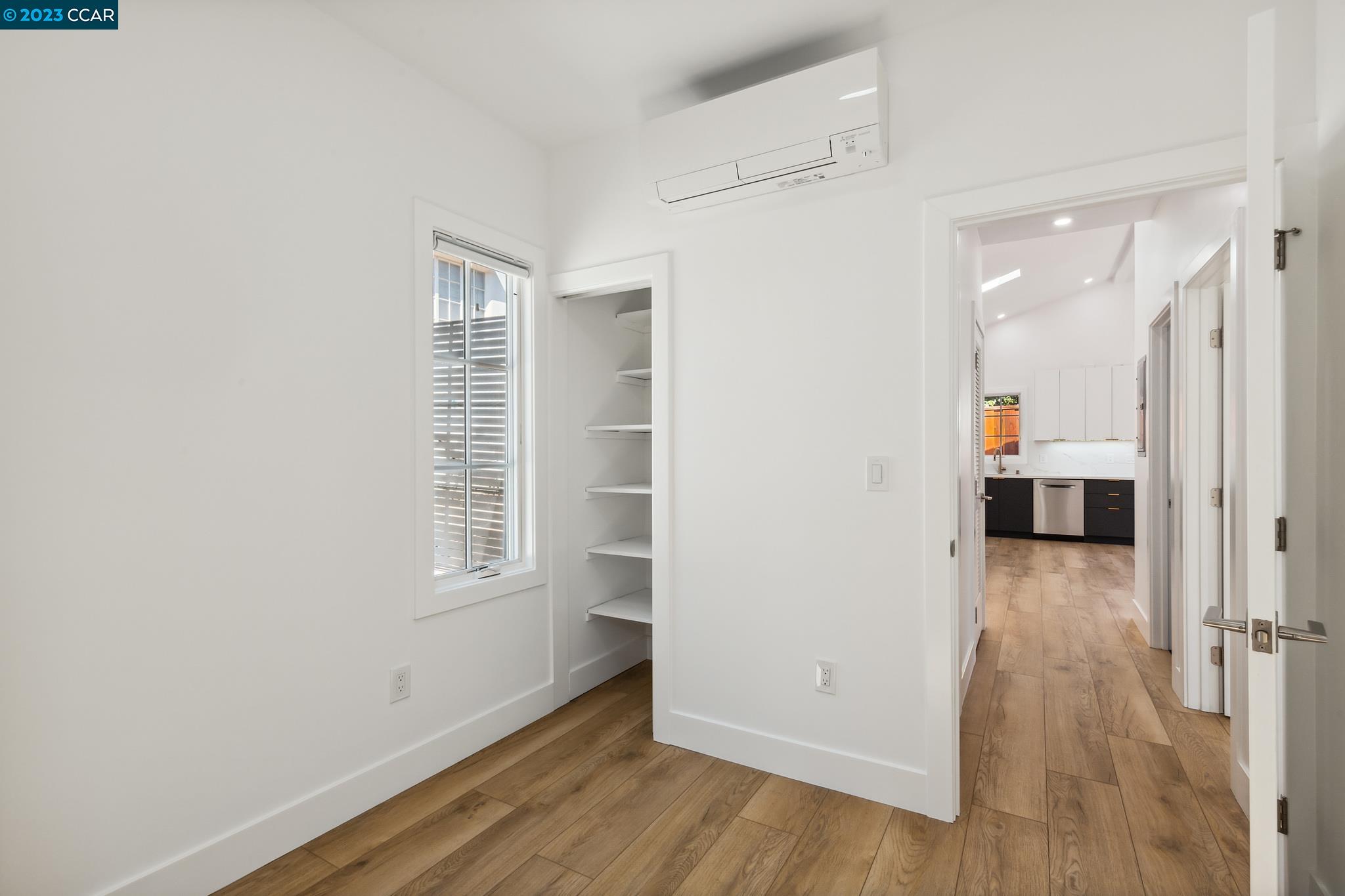 833 Paramount Road Oakland, CA 94610 - Photo 10 of 15 an empty room with wooden floor and windows