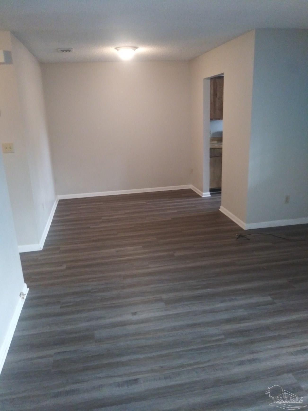 6288 Hamilton Bridge Road, Unit 501 Milton, FL 32570 - Photo 4 of 12 a view of an empty room with wooden floor