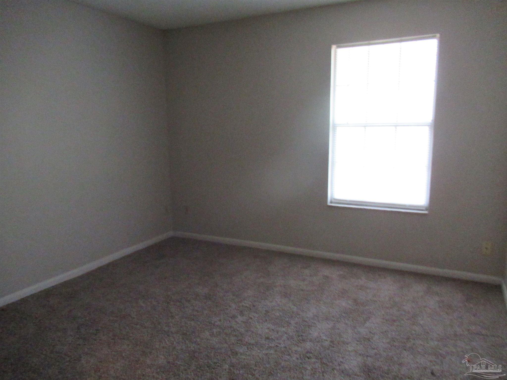 6288 Hamilton Bridge Road, Unit 501 Milton, FL 32570 - Photo 5 of 12 an empty room with a window