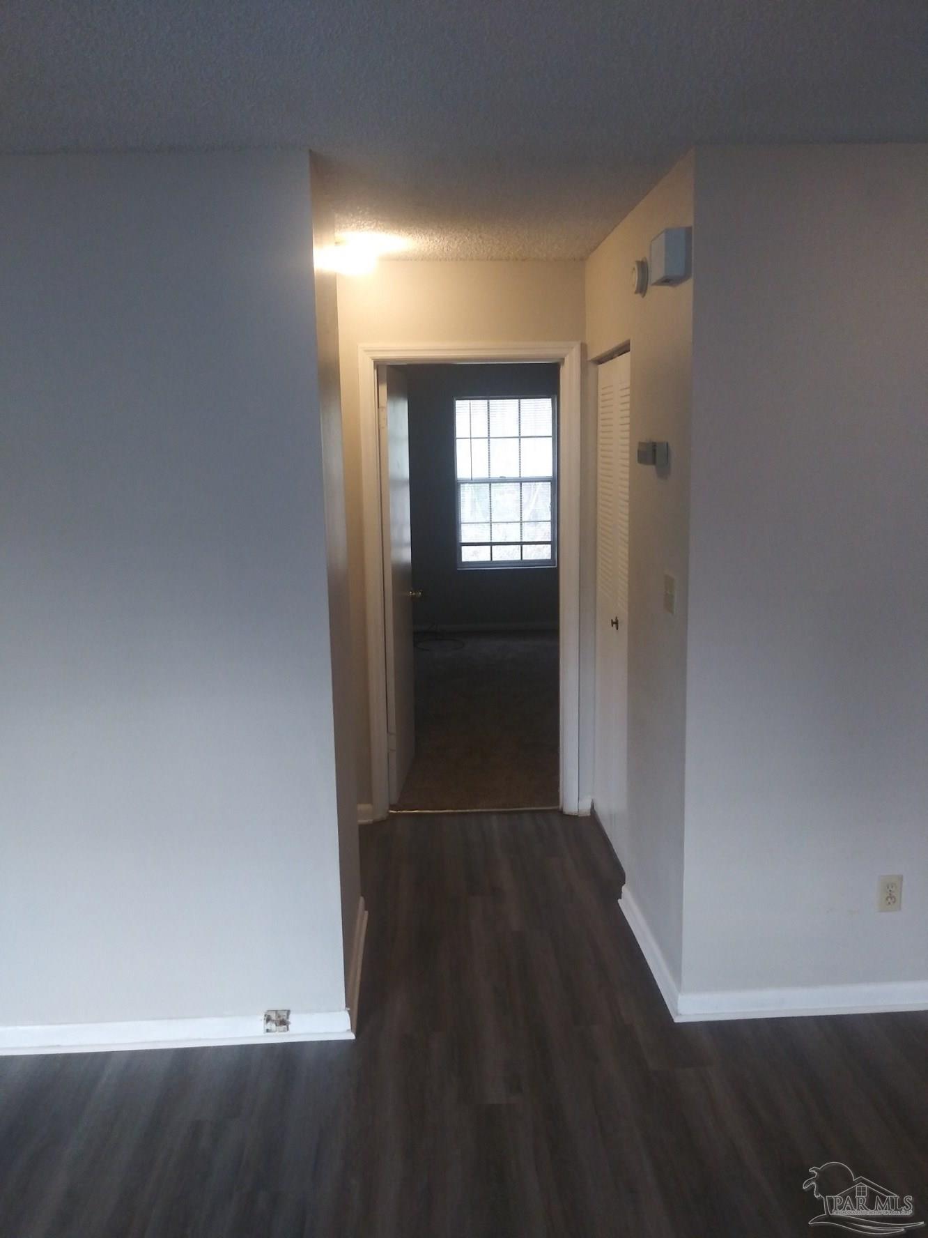 6288 Hamilton Bridge Road, Unit 501 Milton, FL 32570 - Photo 6 of 12 an empty room with wooden floor and windows