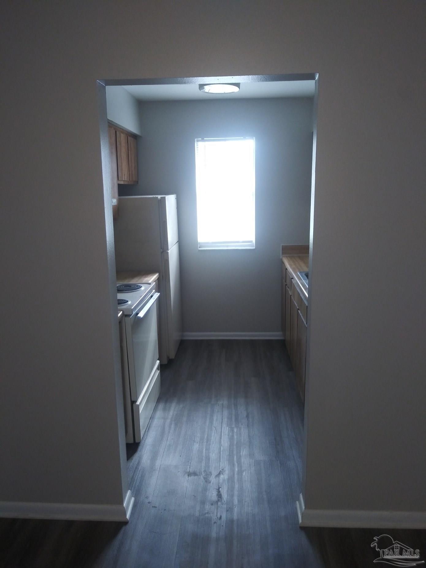 6288 Hamilton Bridge Road, Unit 501 Milton, FL 32570 - Photo 7 of 12 a view of hallway with wooden floor and cabinet