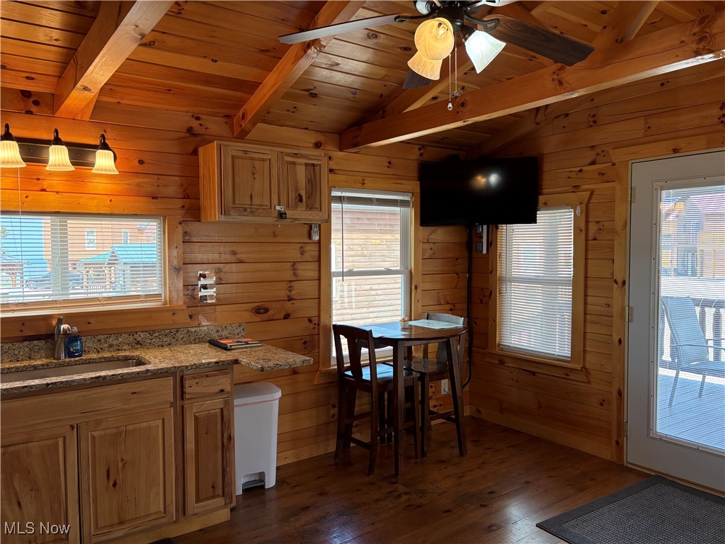 5919 Lake Road West, Unit 15 Ashtabula, OH 44004 - Photo 7 of 26 Kitchen featuring light stone countertops, dark wood finished floors, wooden ceiling, wood walls, and plenty of natural light