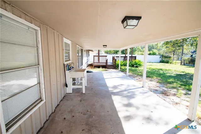 a view of a porch with wooden floor and outer view