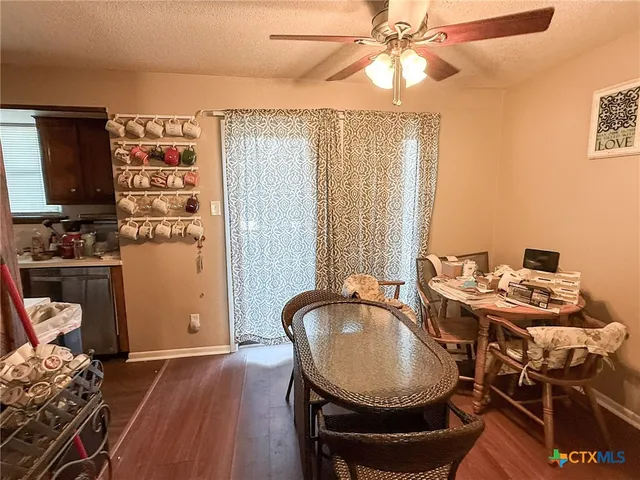 a dining room with furniture and wooden floor