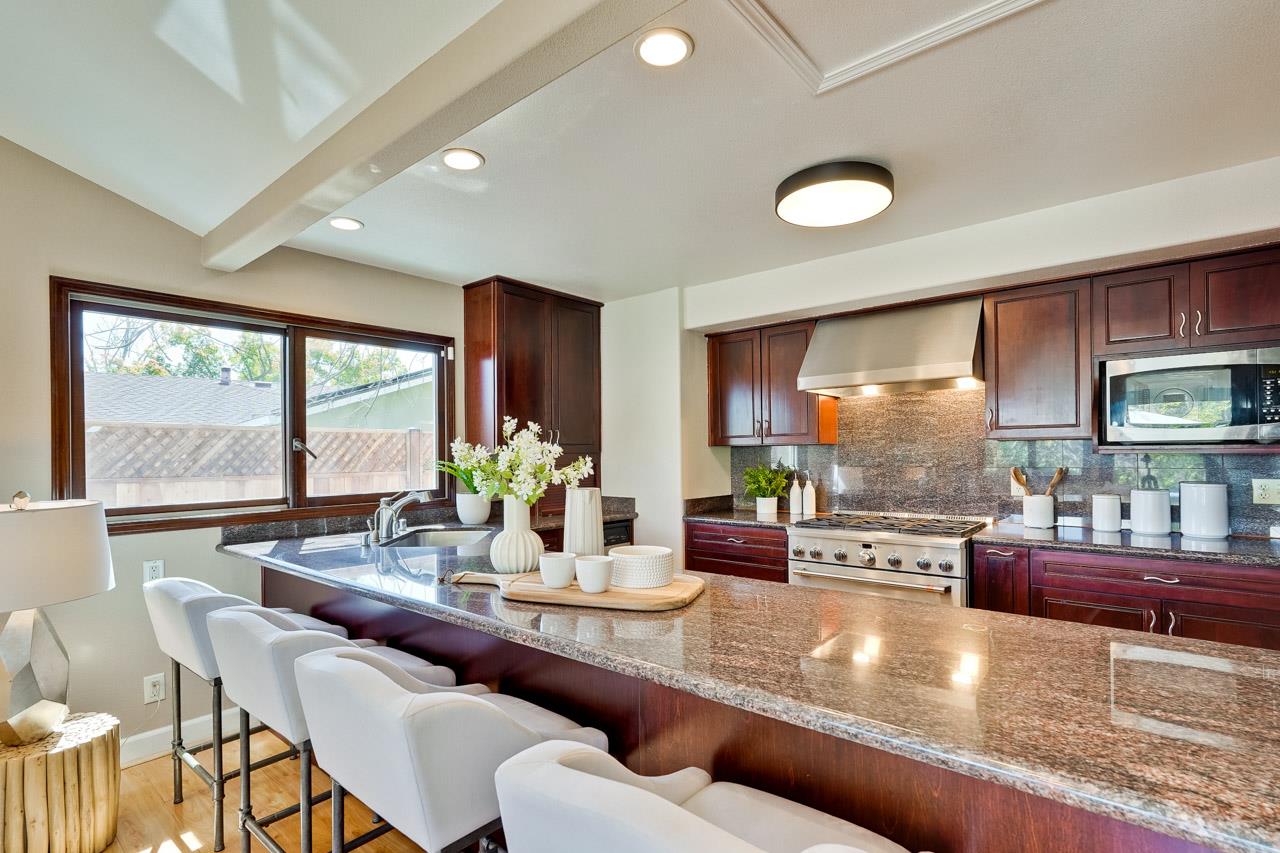 942 September Drive Cupertino, CA 95014 - Photo 12 of 51 a dining room with furniture a large window and a rug
