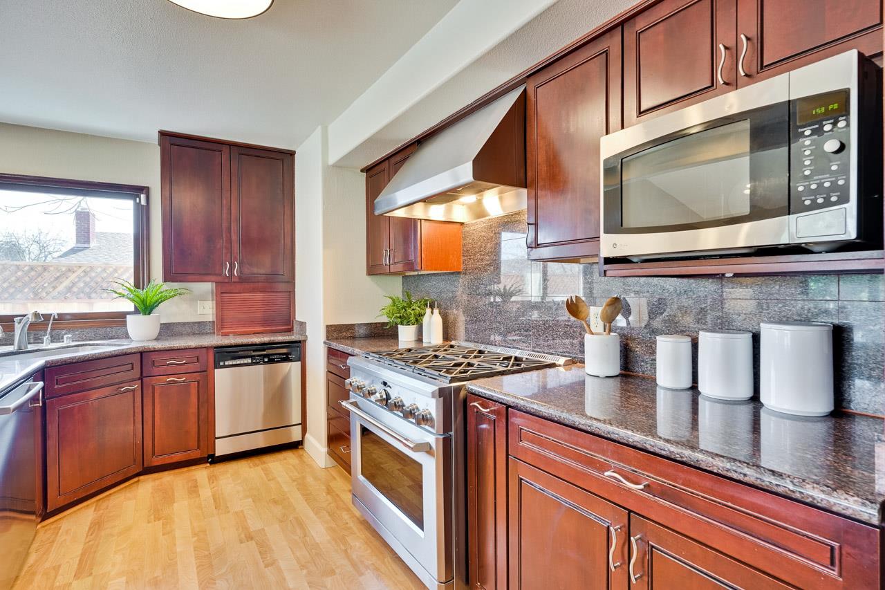942 September Drive Cupertino, CA 95014 - Photo 14 of 51 a kitchen with stainless steel appliances granite countertop a sink a stove a microwave a counter space and cabinets
