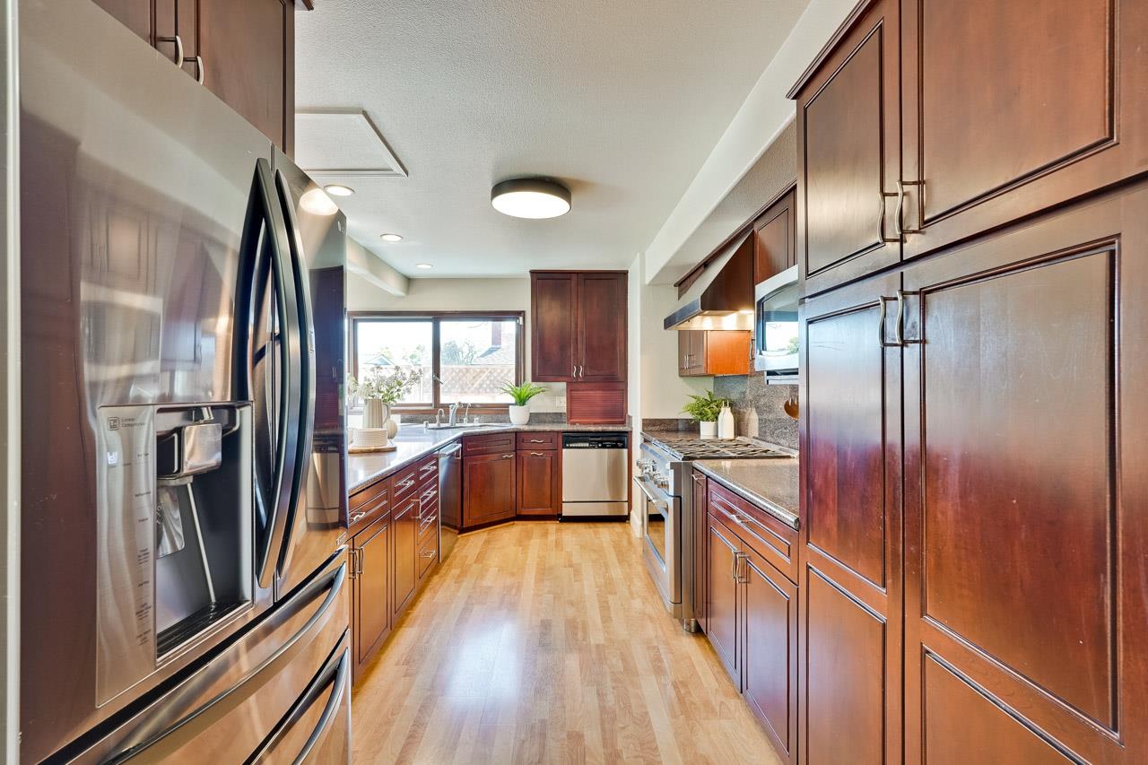 942 September Drive Cupertino, CA 95014 - Photo 15 of 51 a kitchen with stainless steel appliances granite countertop a refrigerator a sink and wooden cabinets