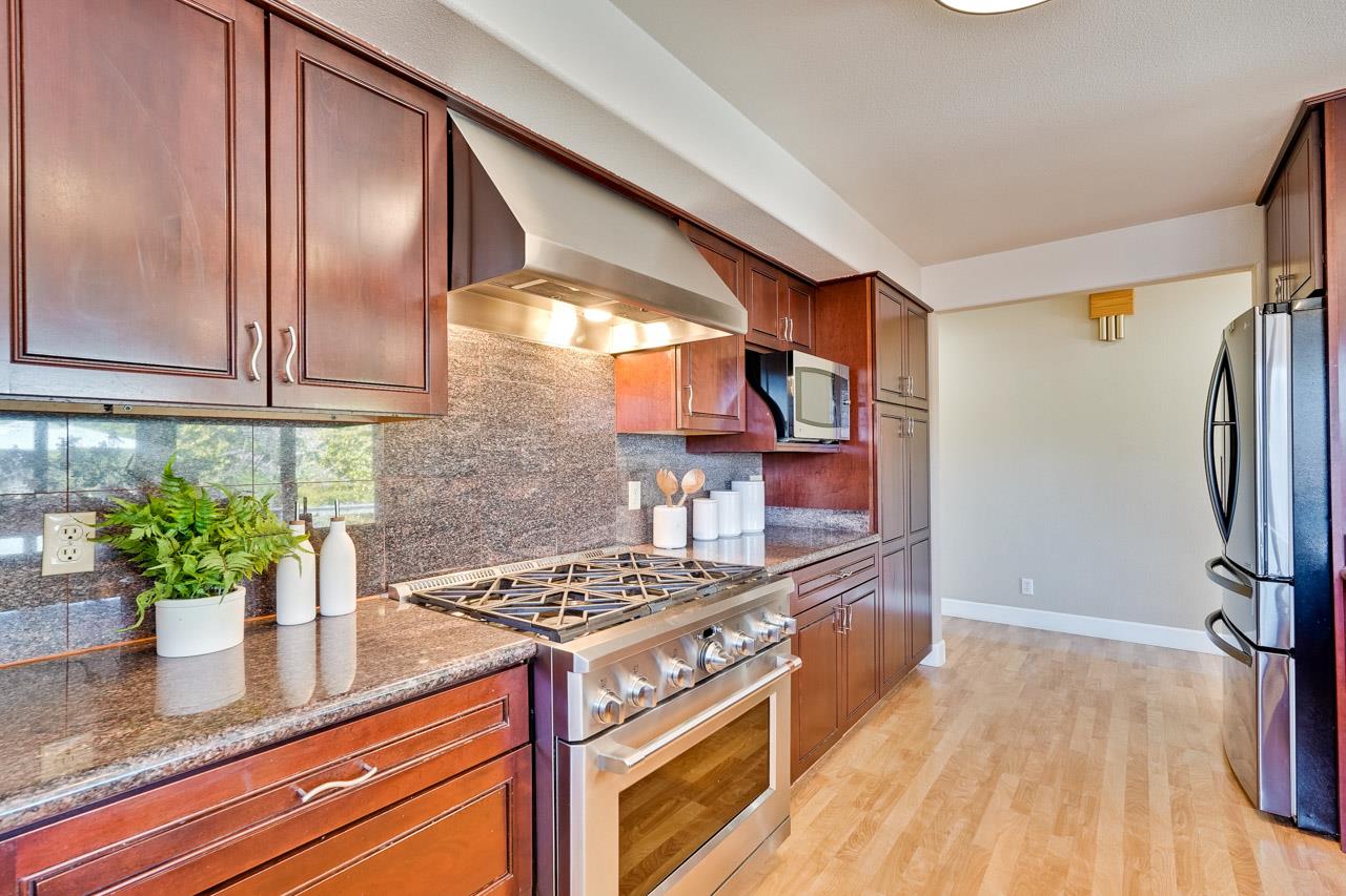 942 September Drive Cupertino, CA 95014 - Photo 16 of 51 a kitchen with stainless steel appliances granite countertop a stove a sink and a refrigerator