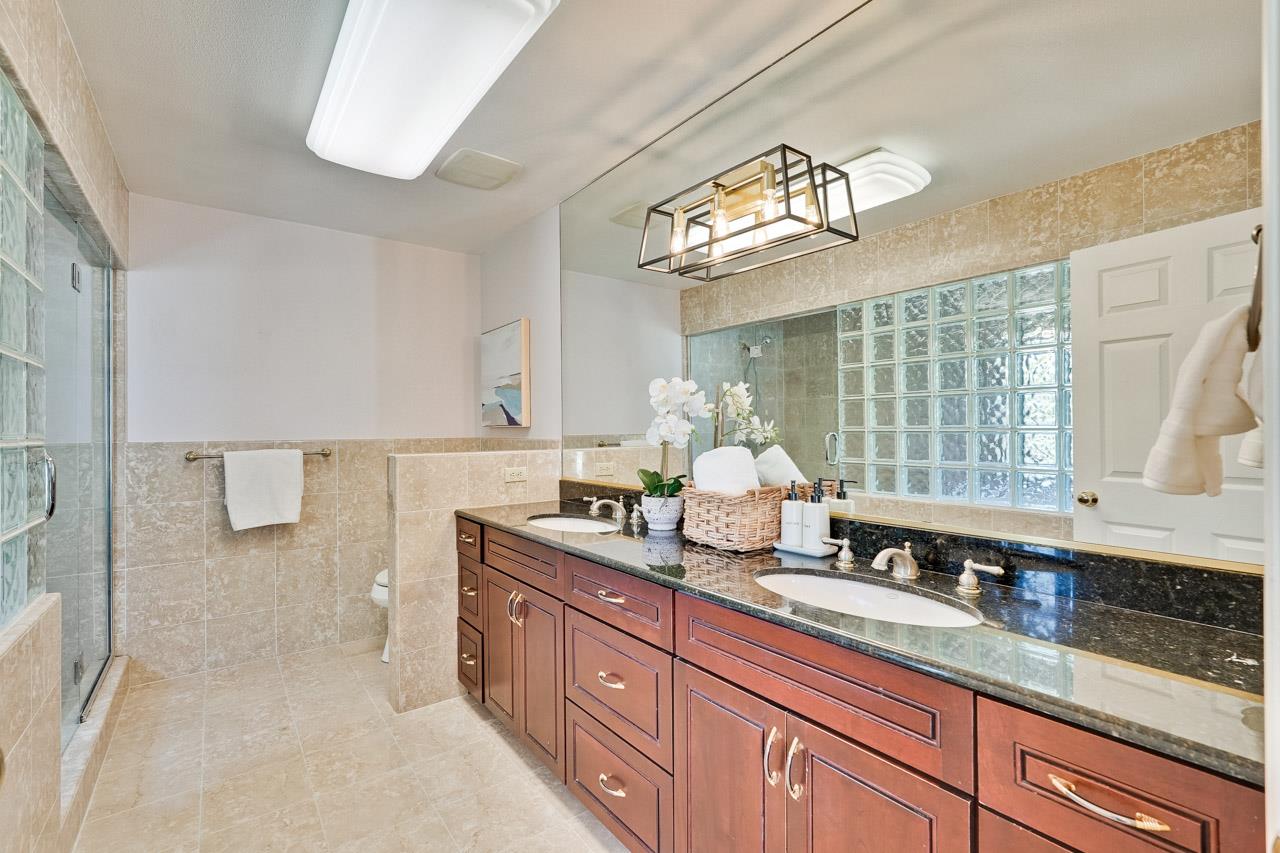 942 September Drive Cupertino, CA 95014 - Photo 32 of 51 a bathroom with a sink a large mirror and a bathtub next to a window
