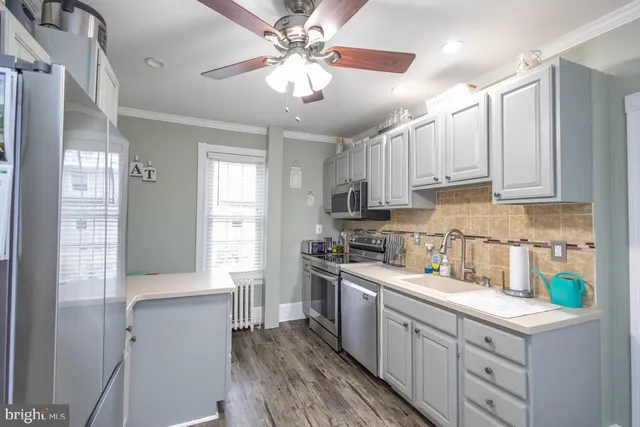a kitchen with a white cabinets stove and refrigerator