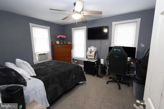 a bedroom with a bed and a television