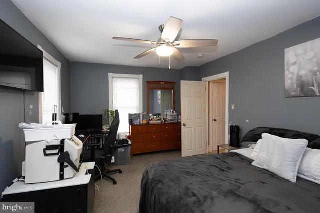 a bedroom with furniture and a window