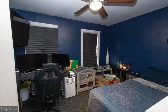 a bedroom with bed and a chandelier